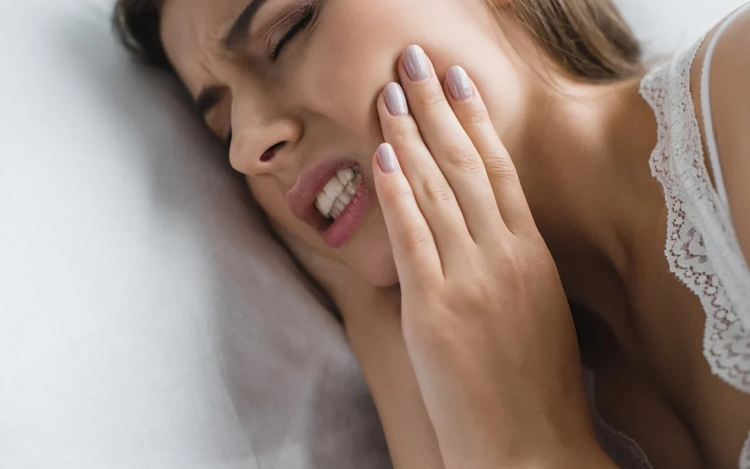 young woman suffering from tooth pain